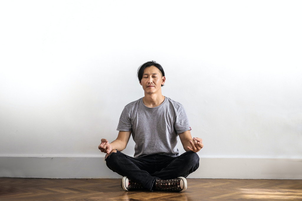 A man sitting crossed legged in deep meditation